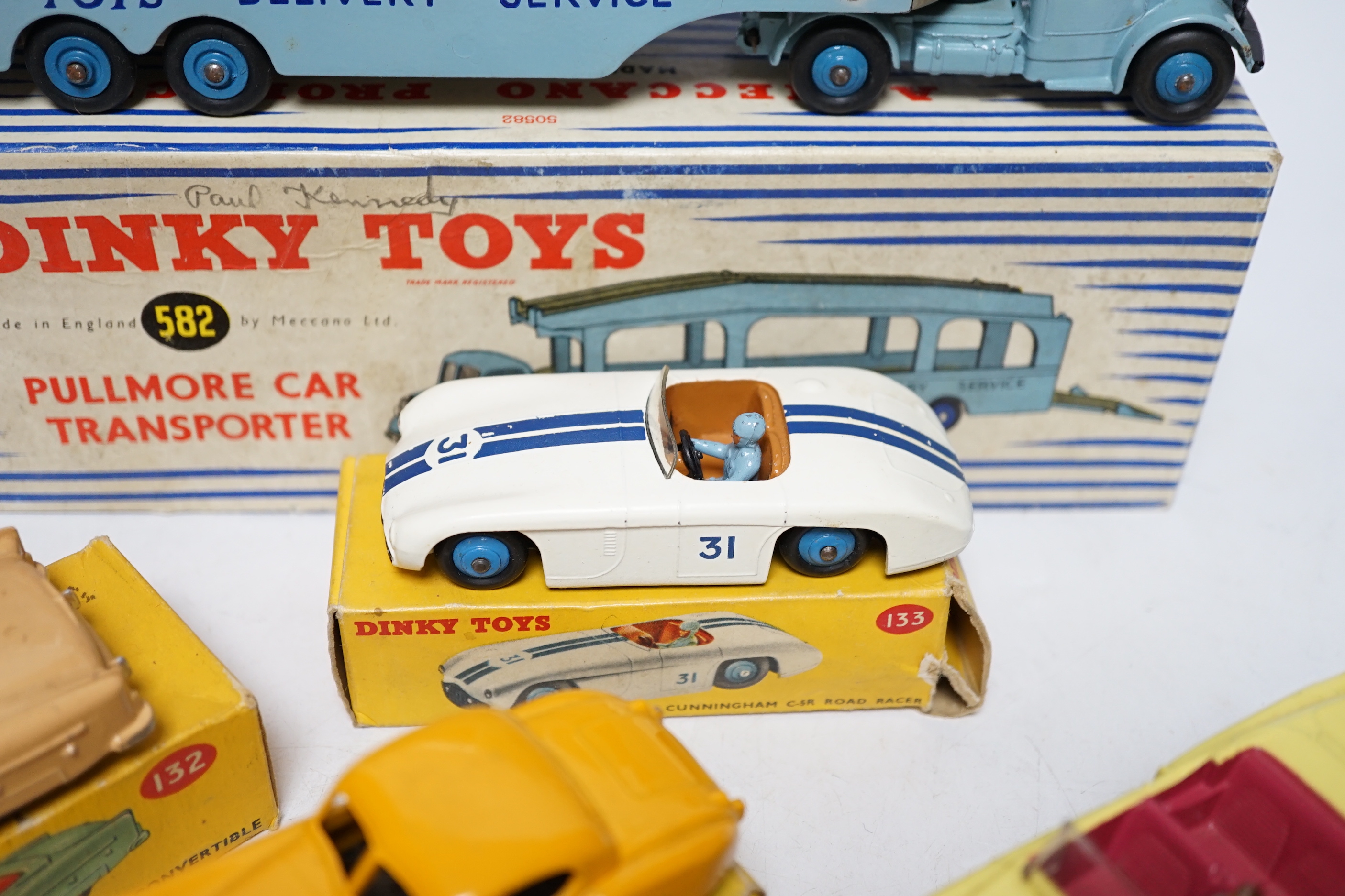 Five boxed Dinky Toys; (132) a Packard Convertible, (131) a Cadillac Tourer, (133) a Cunningham C-5R road racer, (157) a Jaguar XK120 and (582) a Pullmore Car Transporter with a (994) Loading Ramp, together with a Cresce